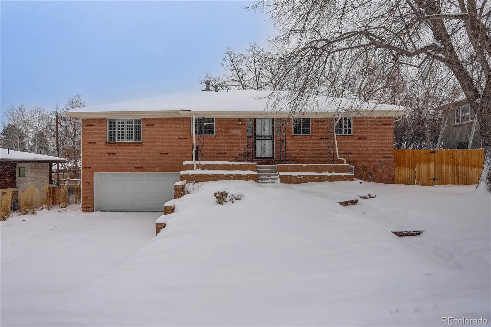 a front view of a house with yard covered in snow