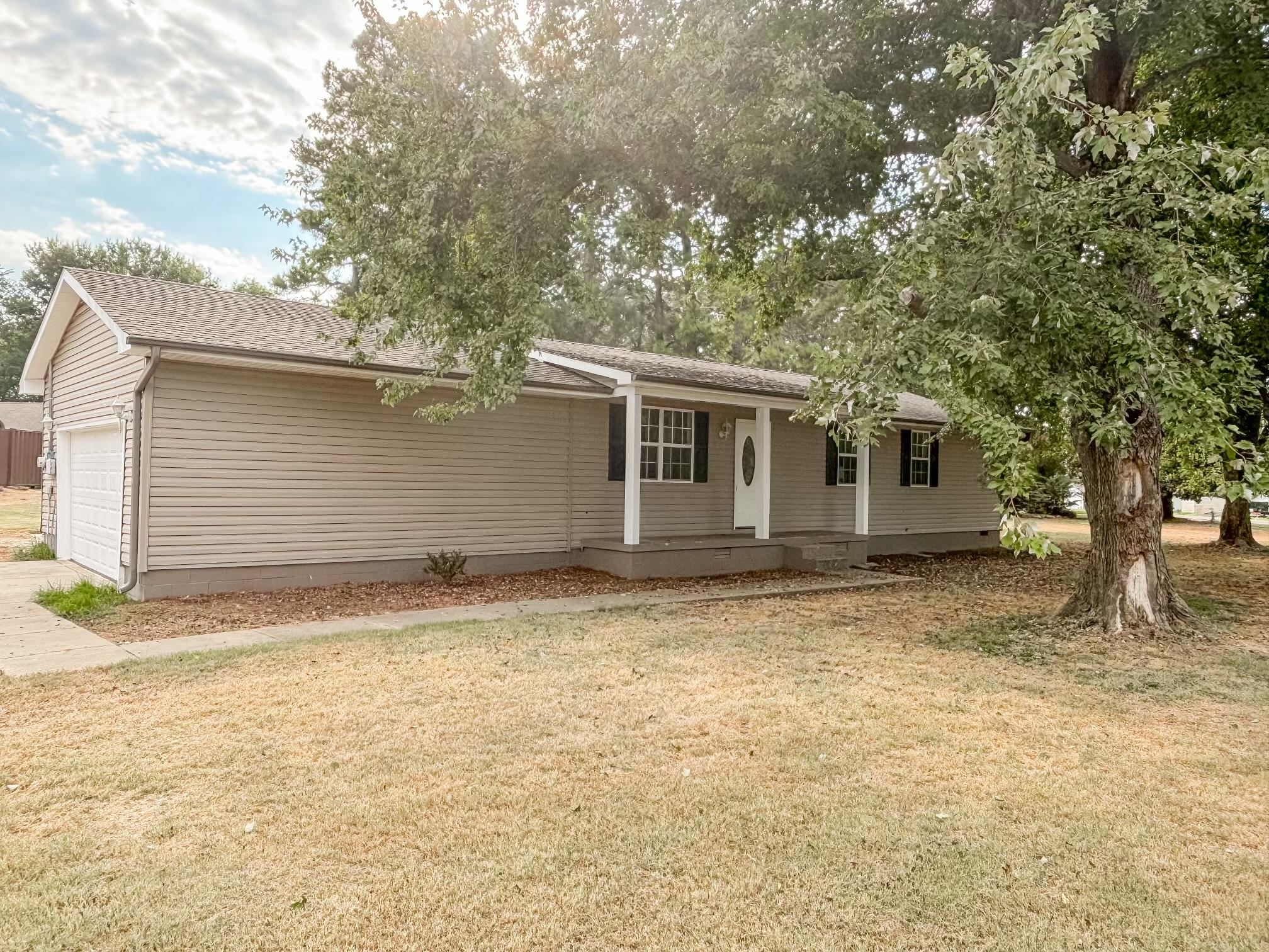 1695 Dawson Road Brighton, TN 38011 - Photo 1 of 13 Ranch-style home featuring a garage, covered porch, and a front yard