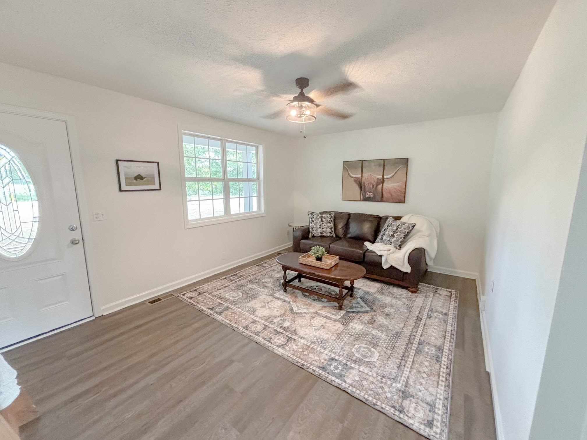 1695 Dawson Road Brighton, TN 38011 - Photo 3 of 13 Living room featuring a textured ceiling, ceiling fan, and hardwood / wood-style flooring