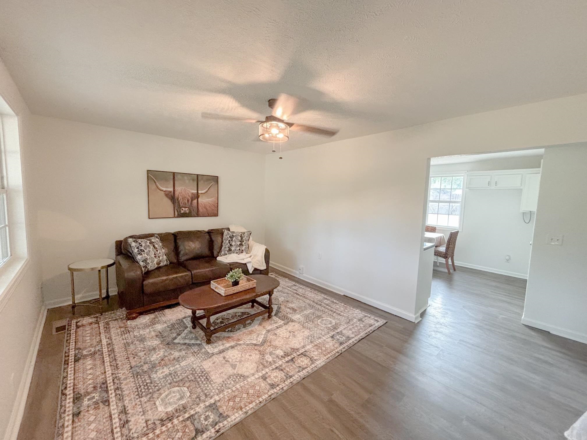 1695 Dawson Road Brighton, TN 38011 - Photo 4 of 13 Living room featuring dark wood-type flooring, ceiling fan, and a textured ceiling