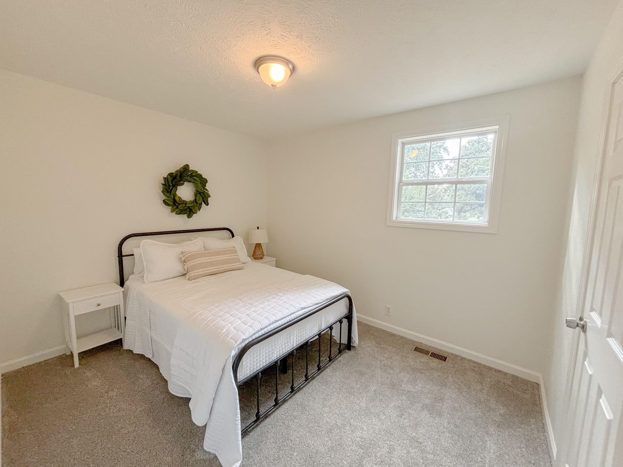 1695 Dawson Road Brighton, TN 38011 - Photo 7 of 13 Bedroom featuring a textured ceiling and light colored carpet