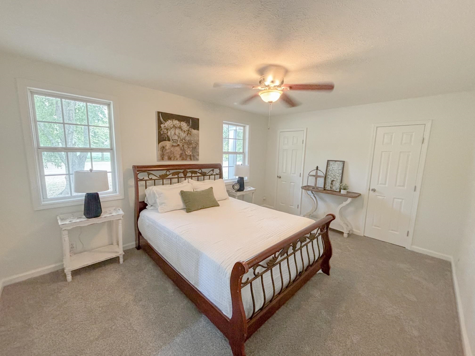 1695 Dawson Road Brighton, TN 38011 - Photo 10 of 13 Bedroom featuring multiple windows, a textured ceiling, ceiling fan, and carpet