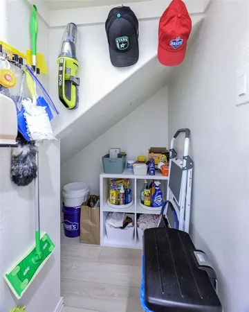 a room with storage and a white refrigerator