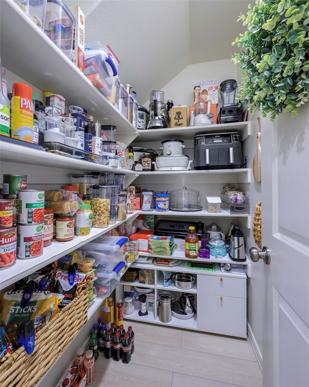 1311 Union Road Celina, TX 75009 - Photo 12 of 38 a room with storage and a white refrigerator