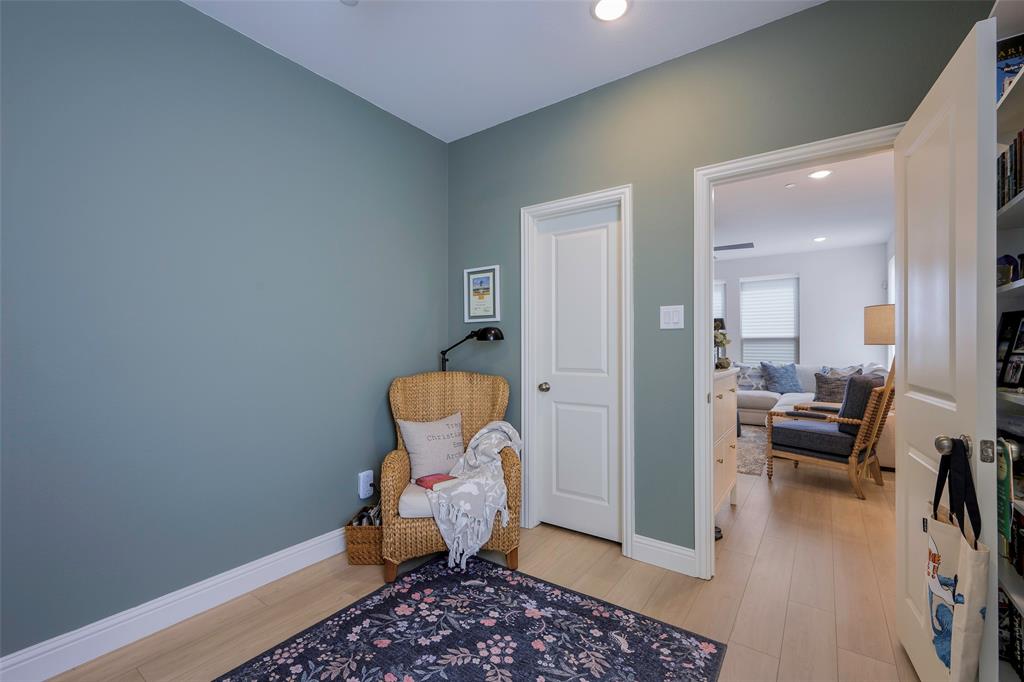 1311 Union Road Celina, TX 75009 - Photo 17 of 38 a room with furniture and a wooden floor