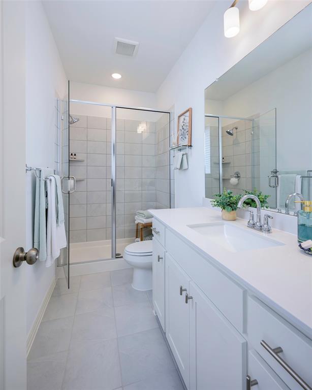 1311 Union Road Celina, TX 75009 - Photo 18 of 38 a spacious bathroom with a double vanity sink toilet mirror and shower