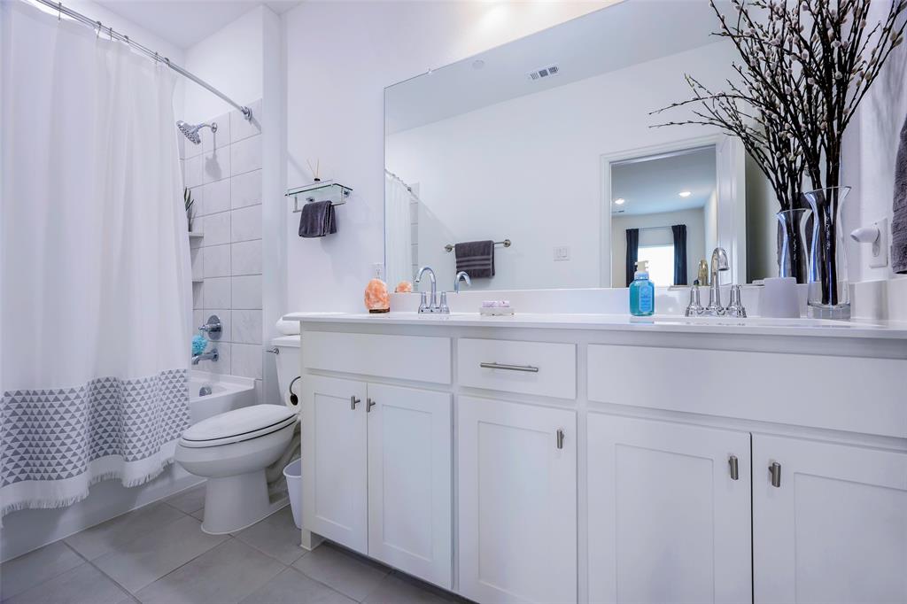 1311 Union Road Celina, TX 75009 - Photo 23 of 38 a bathroom with a double vanity sink mirror and toilet