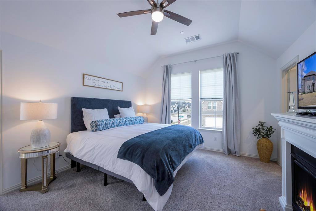 1311 Union Road Celina, TX 75009 - Photo 26 of 38 a spacious bedroom with a bed and a fireplace
