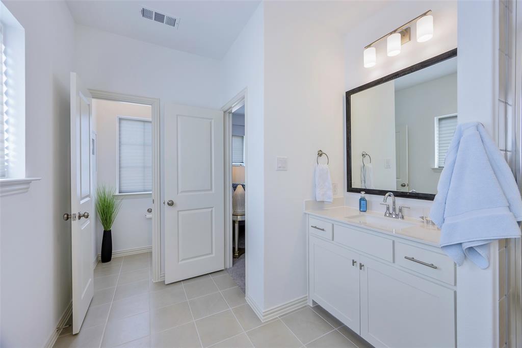1311 Union Road Celina, TX 75009 - Photo 30 of 38 a bathroom with a double vanity sink and a mirror