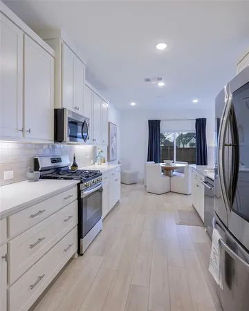 a kitchen with sink cabinets and microwave