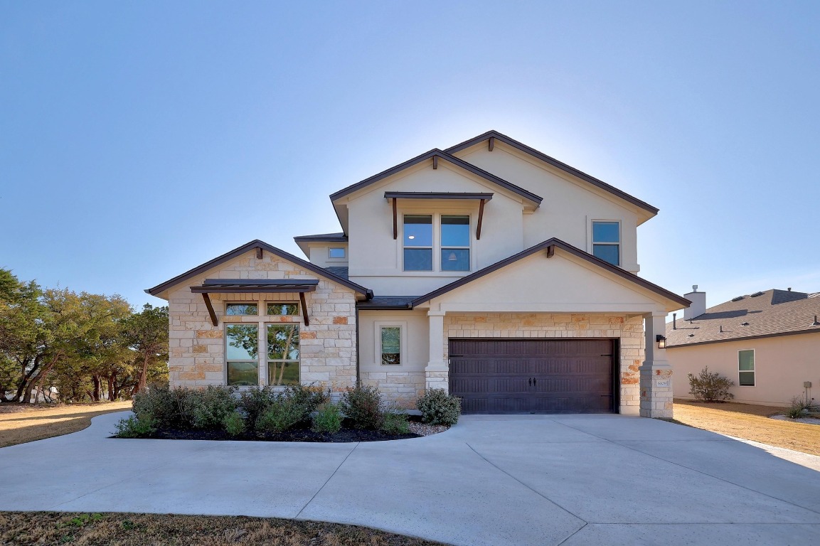 a front view of a house with a yard and garage