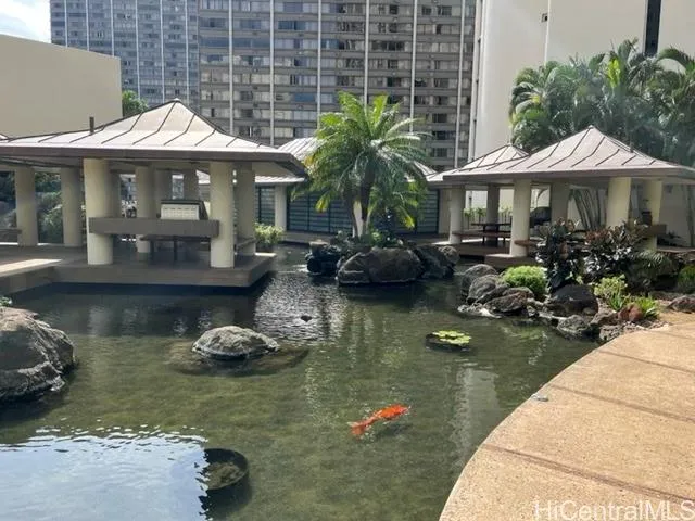 a view of a patio with table and chairs under an umbrella