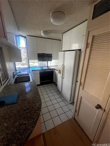 a kitchen with a refrigerator sink and stove