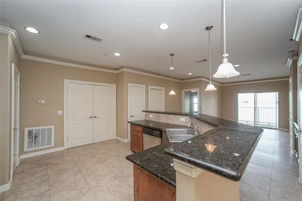 a kitchen with stainless steel appliances granite countertop a sink a stove and a window