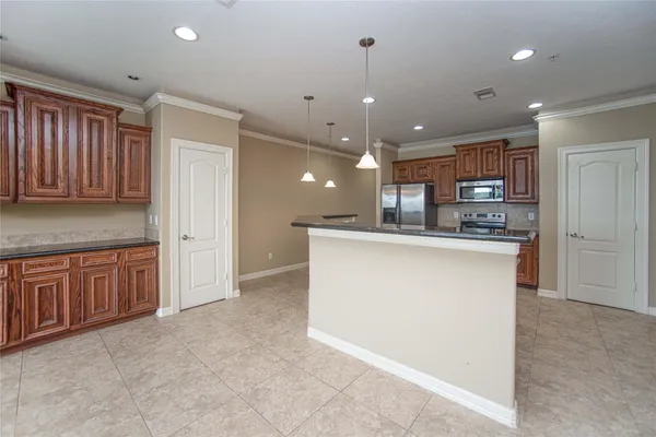 a kitchen with stainless steel appliances granite countertop a refrigerator a sink dishwasher and a oven