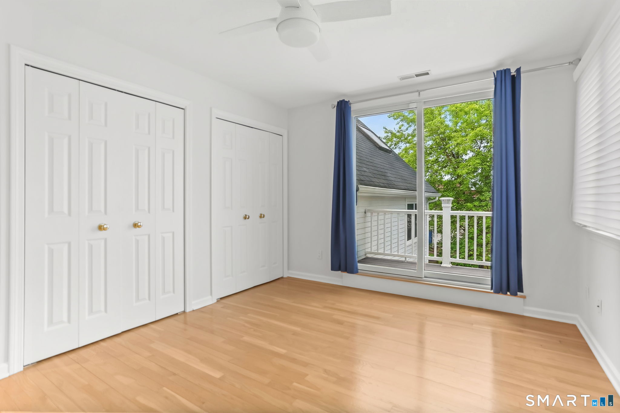 1149 Fairfield Beach Road Fairfield, CT 06824 - Photo 28 of 40 a view of an empty room with wooden floor and a window