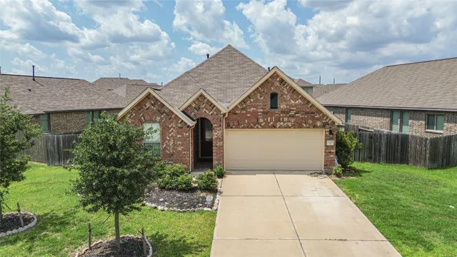 a front view of a house with a garden and plants