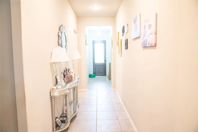 a hallway with a white stove next to a white house
