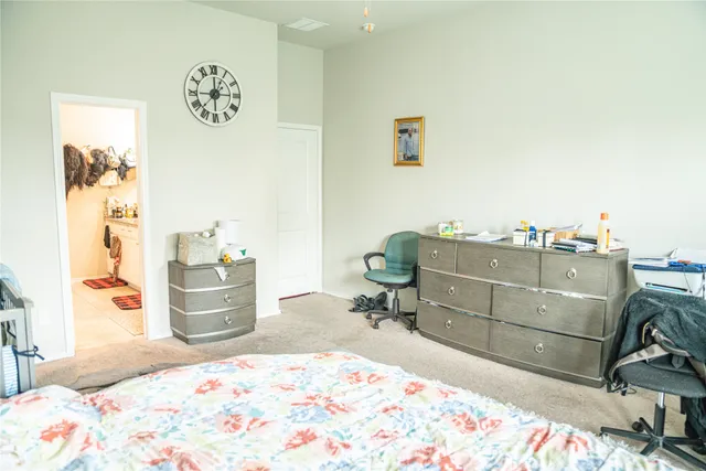 a bedroom with a bed and cabinets