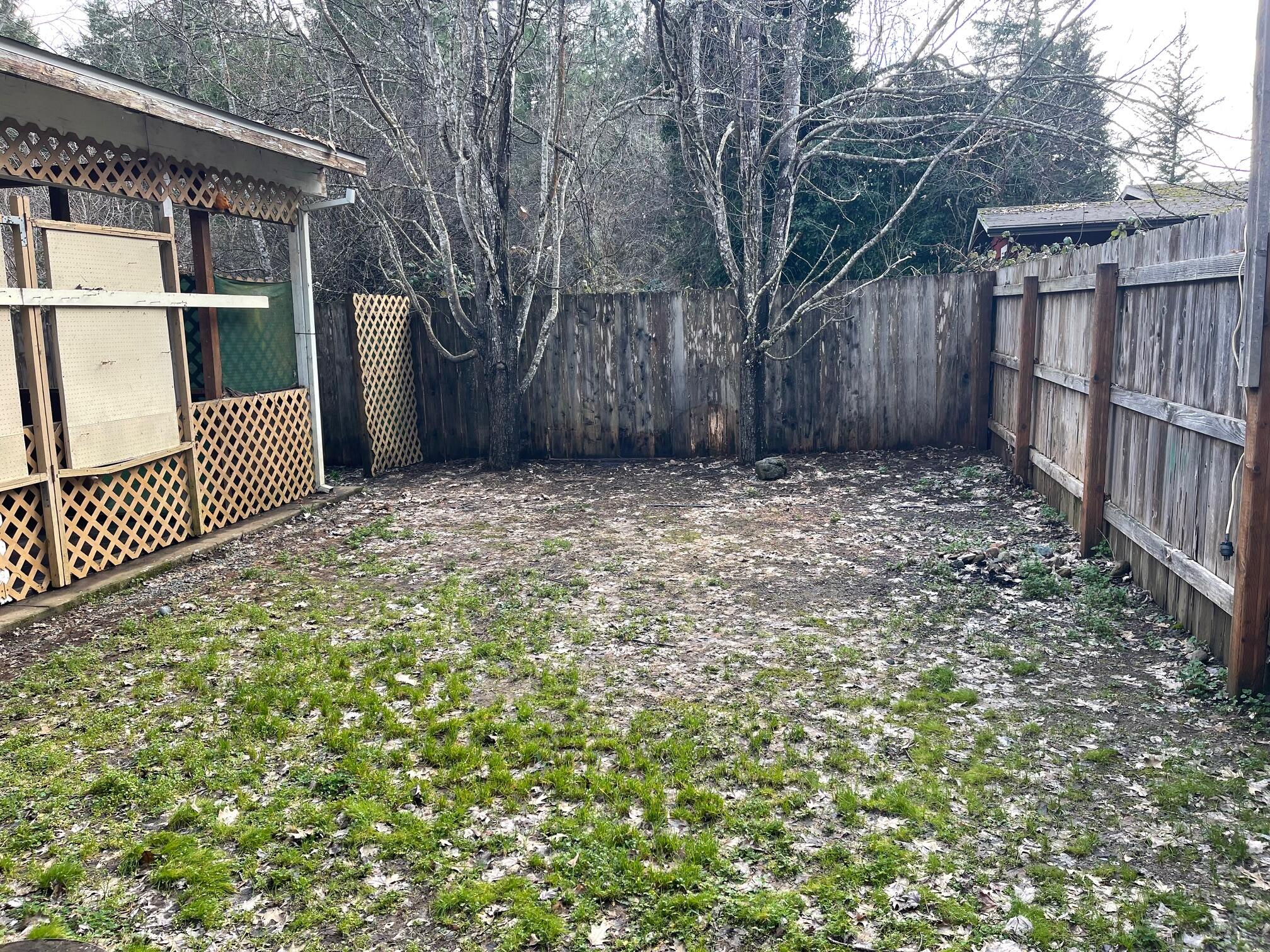 411 South Old Stage Road Cave Junction, OR 97523 - Photo 3 of 39 a view of a yard with wooden fence