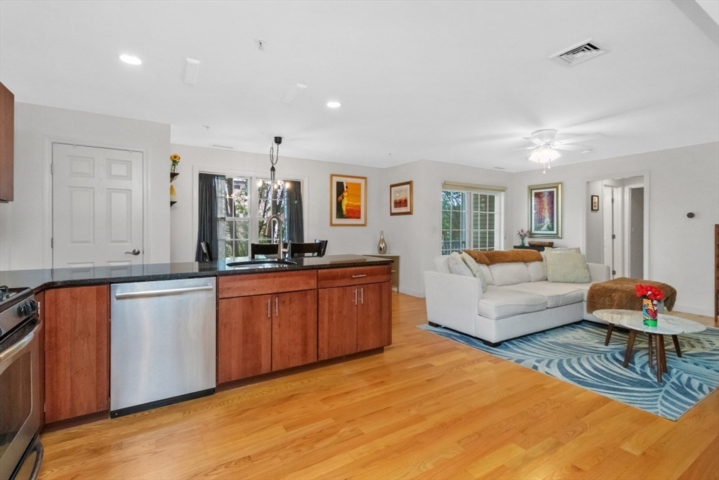29 Spruce Street, Unit 23 Waltham, MA 02453 - Photo 6 of 26 a large white room with large window and wooden floor