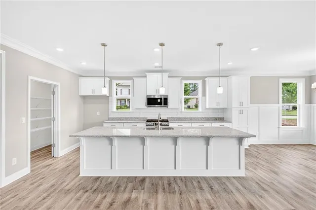 a kitchen with kitchen island stainless steel appliances a sink and a stove