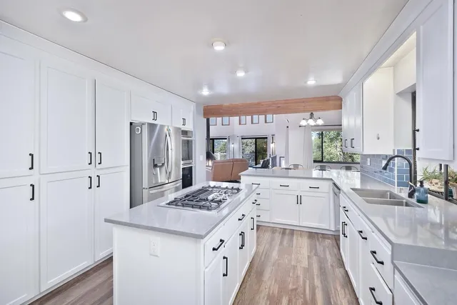 a kitchen with a sink stove and refrigerator