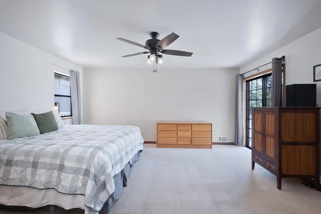 a bedroom with a bed and dresser