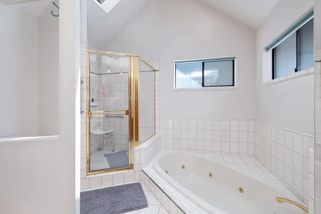 a bathroom with a bathtub and a shower