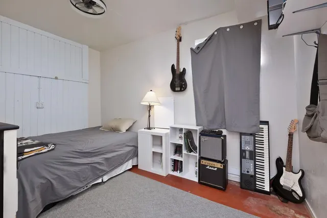 a bedroom with furniture and a flat screen tv