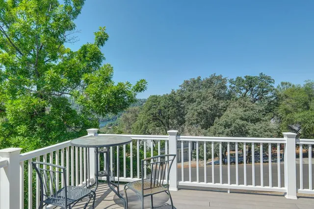 a view of a chair and table in the balcony