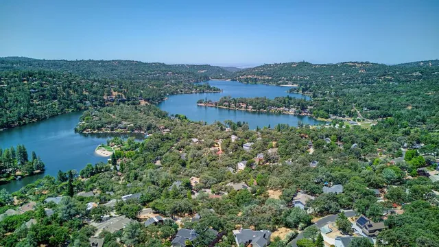a view of a lake and green valley
