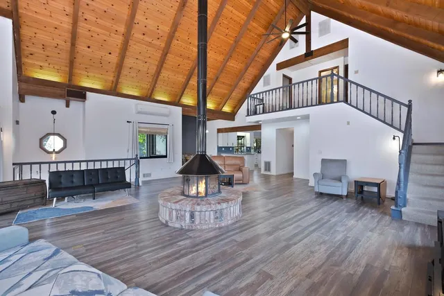 a view of a livingroom with furniture wooden floor and window