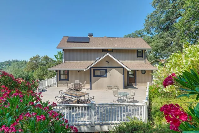 a view of a house with a yard and garden