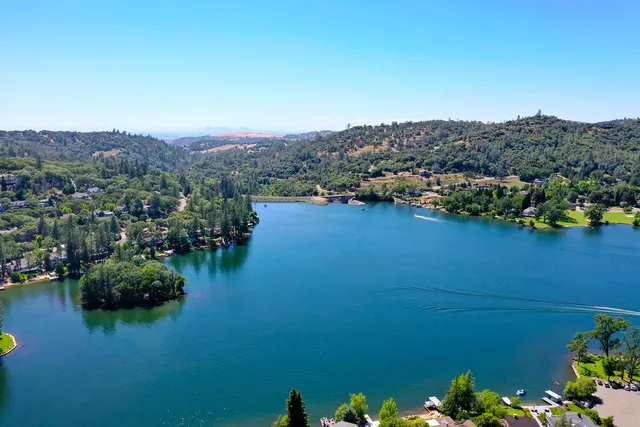 an aerial view of lake and residential houses with outdoor space