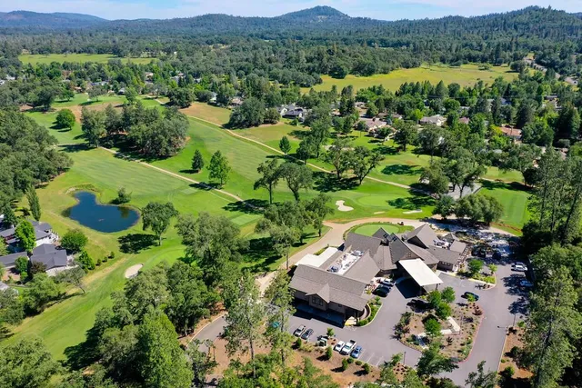 an aerial view of a house with a yard