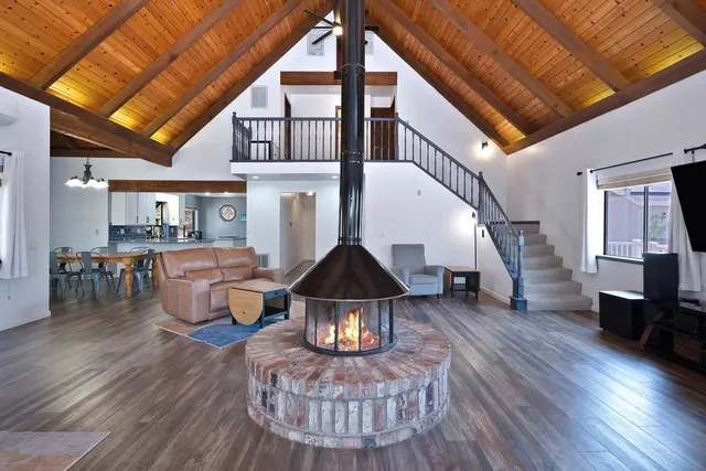 a living room with furniture a wooden floor and a table