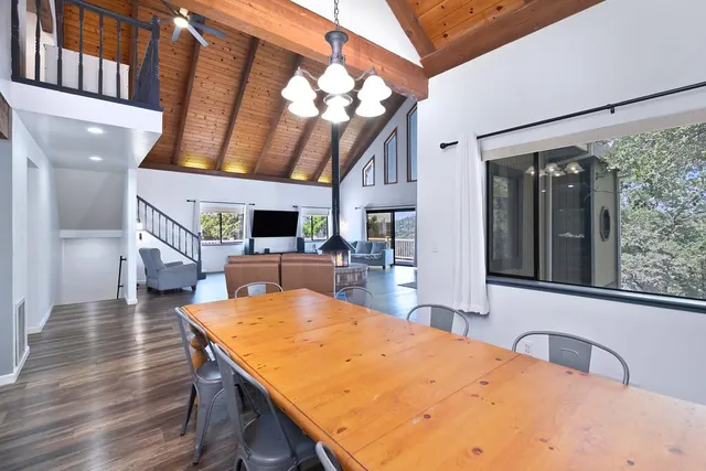 a living room with stainless steel appliances kitchen island furniture and a view of kitchen