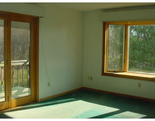 54 Mudnock Road Salisbury, MA 01952 - Photo 6 of 17 a view of an empty room with wooden floor and a window