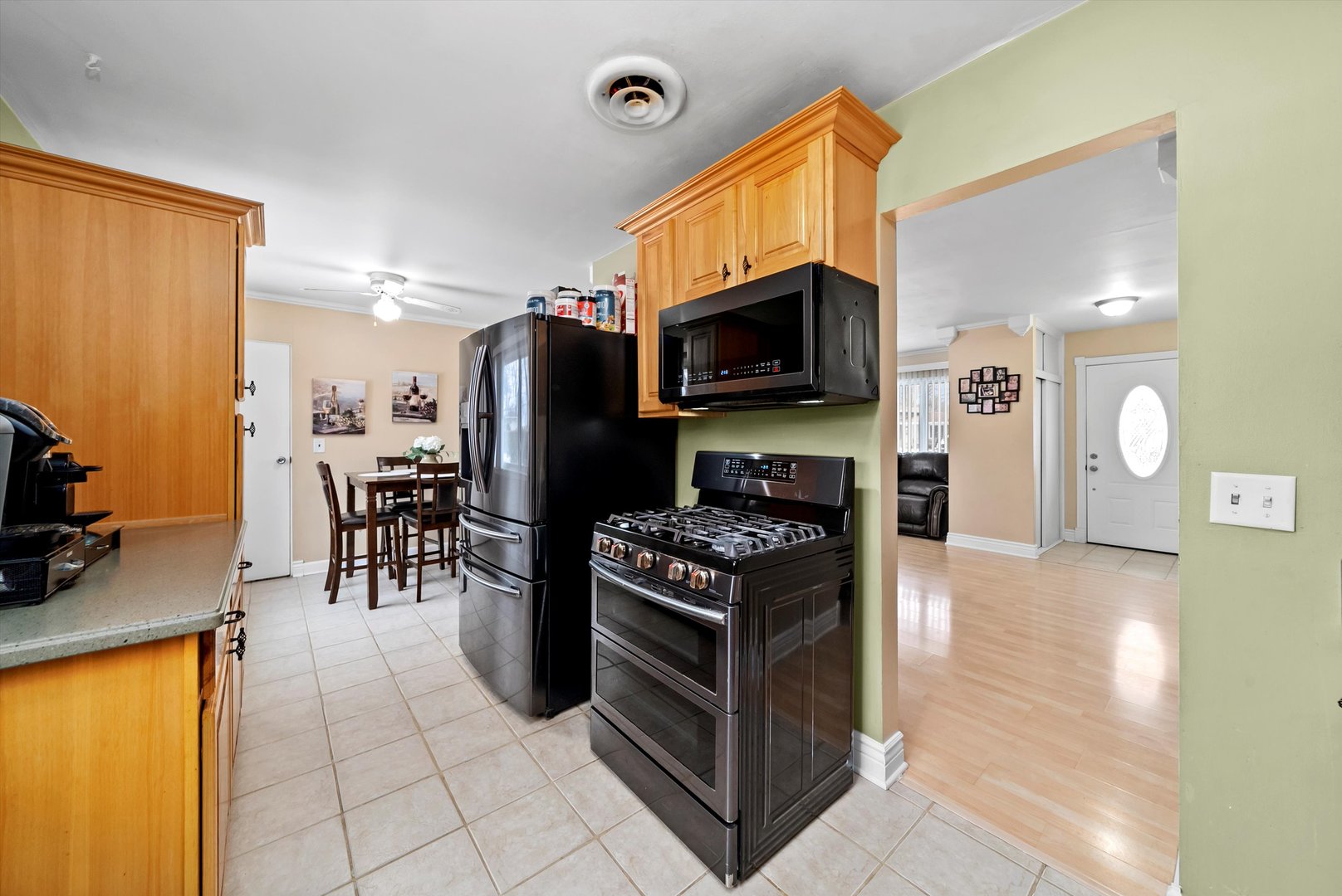 11 Greenfield Road Montgomery, IL 60538 - Photo 6 of 22 a kitchen with stainless steel appliances a stove a microwave a sink a refrigerator and cabinets