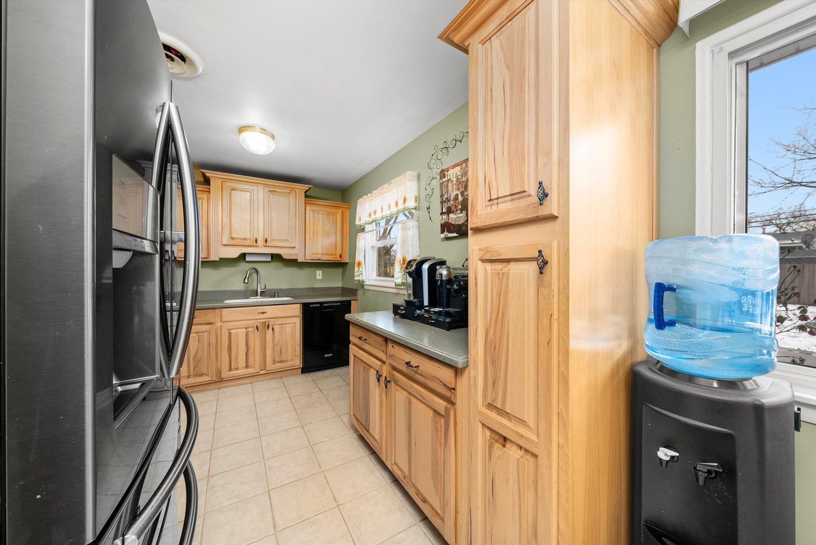 11 Greenfield Road Montgomery, IL 60538 - Photo 10 of 22 a kitchen with stainless steel appliances granite countertop a refrigerator a sink dishwasher a stove and a dining table with wooden floor