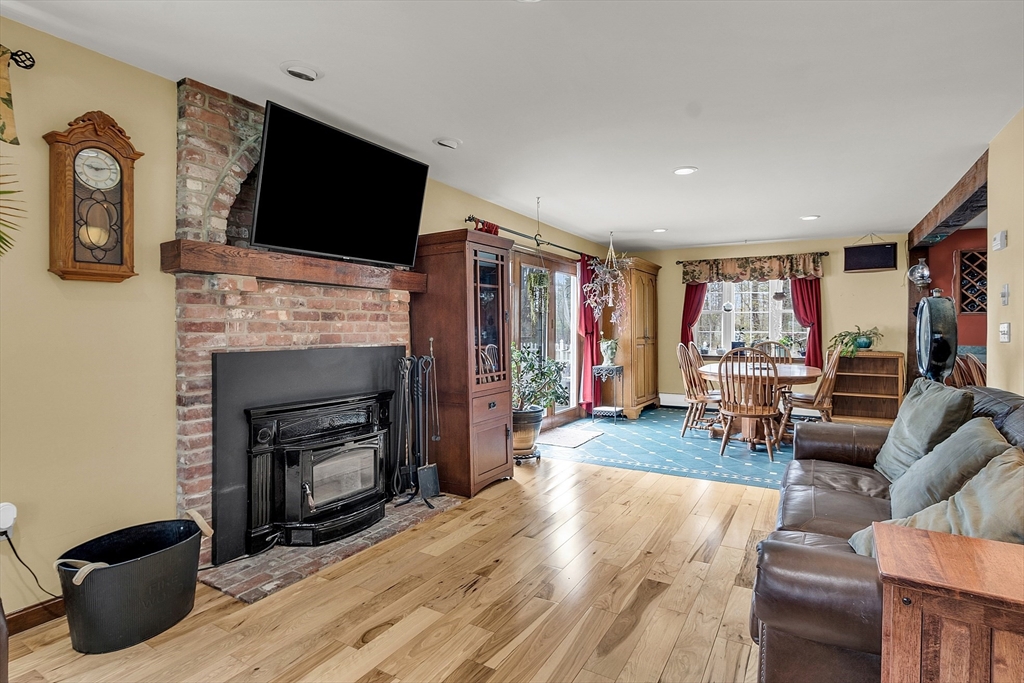 23 Harrington Road Westminster, MA 01473 - Photo 15 of 42 a living room with furniture a flat screen tv and a fireplace
