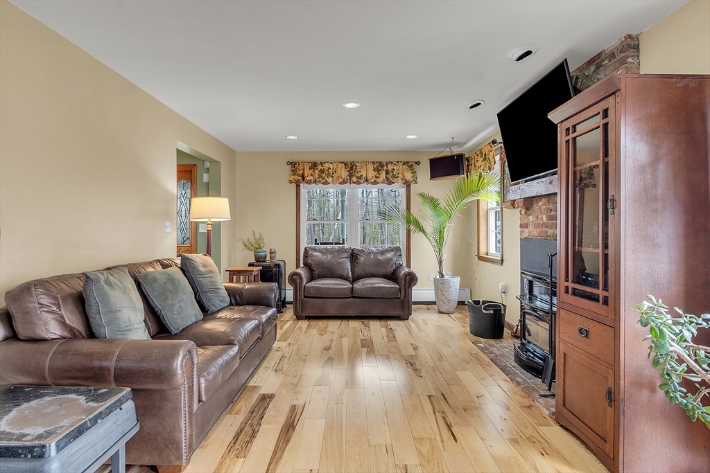 23 Harrington Road Westminster, MA 01473 - Photo 16 of 42 a living room with furniture fireplace and large windows