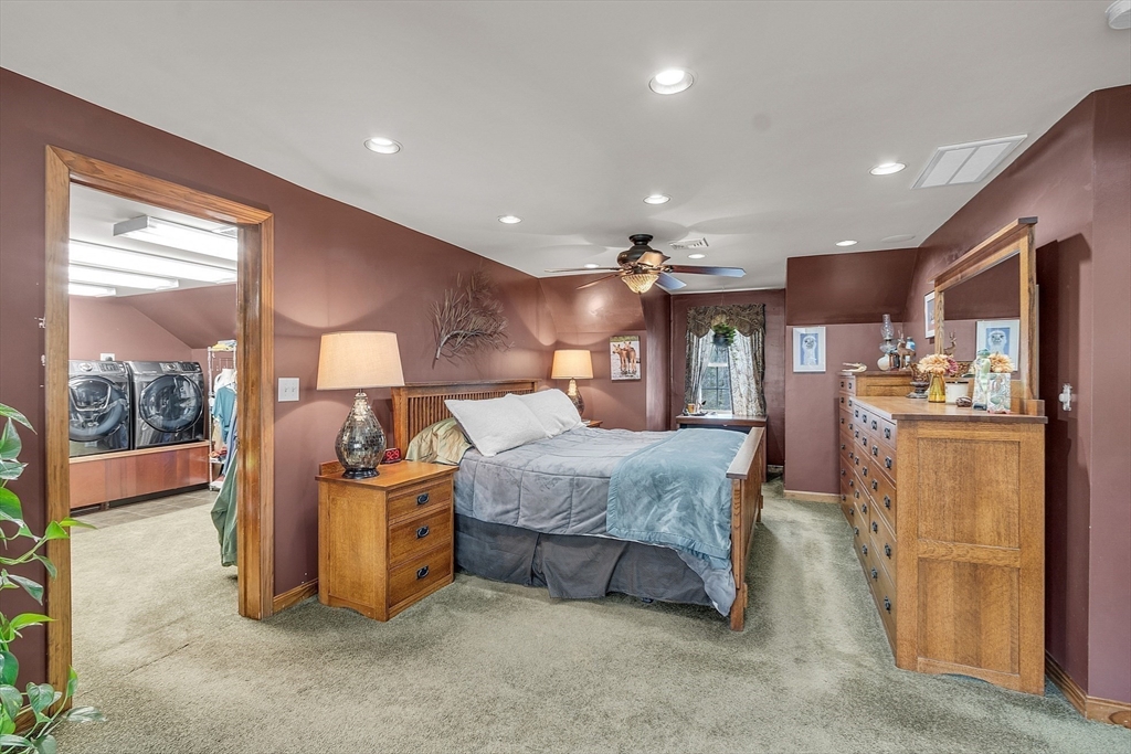 23 Harrington Road Westminster, MA 01473 - Photo 29 of 42 a spacious bedroom with a large bed and a chandelier