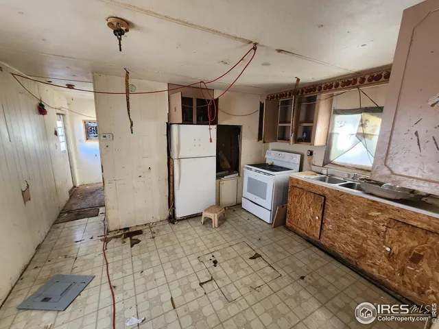 a large kitchen with stainless steel appliances granite countertop a stove a sink dishwasher a dining table and chairs with wooden floor