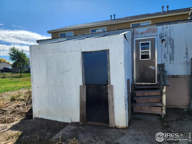 a view of front door and potted plants