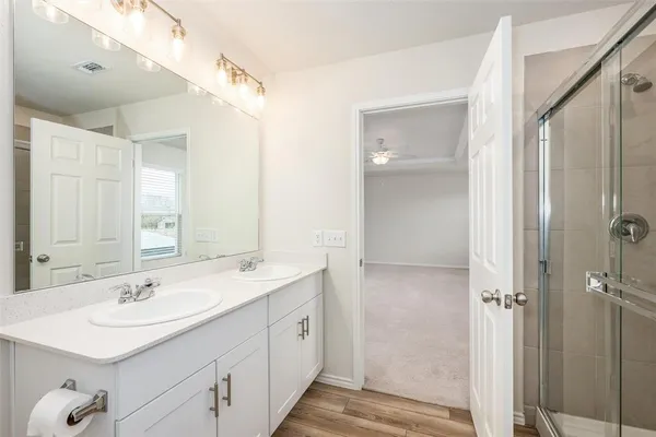 a bathroom with a sink double vanity and a mirror