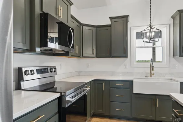 an empty room with wooden floor ceiling fan and windows