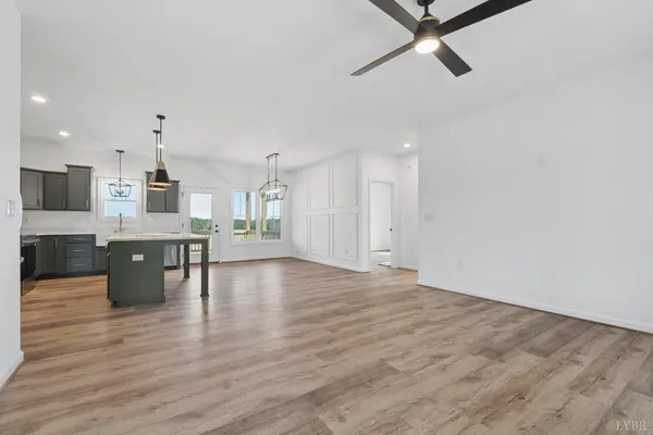 a view of a bedroom with wooden floor and a window