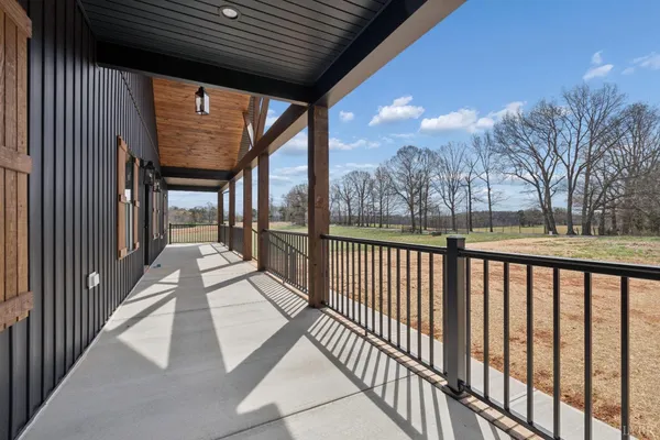 a view of a porch with wooden floor and outdoor space